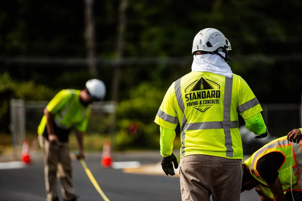 An employee of Standard Paving & Concrete with a helmet on a road