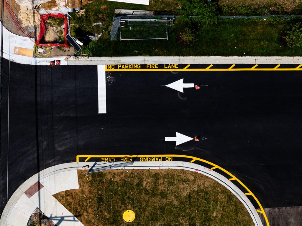 An aerial view of a road with arrows