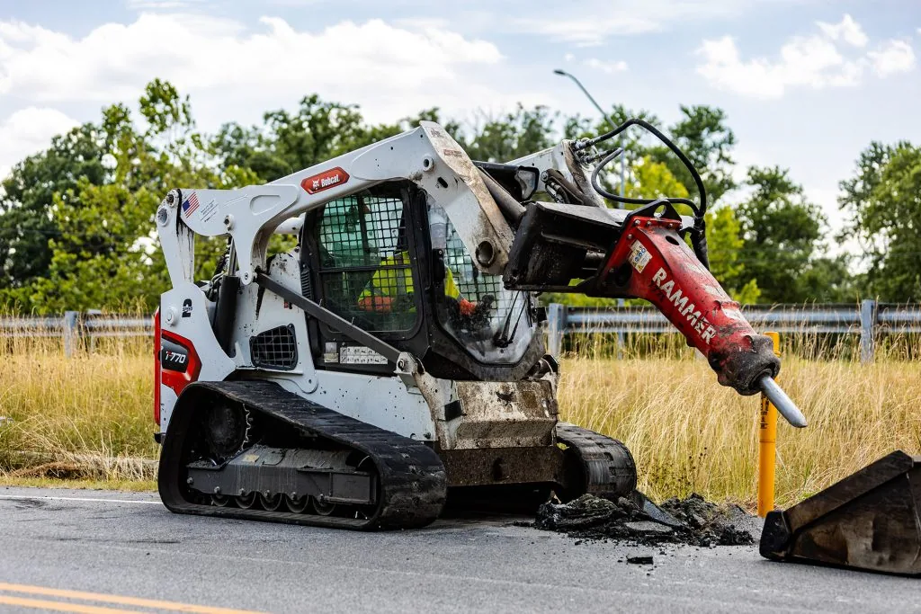 A Bobcat working on a road
