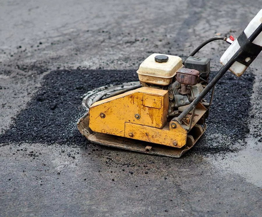 Pothole patching job during parking lot repair.