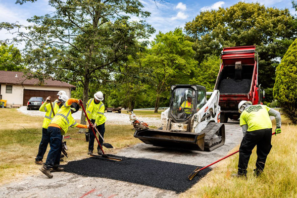 a group of construction workers working on a road
