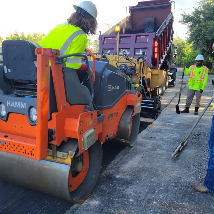 Worker in Truck Laying Asphalt