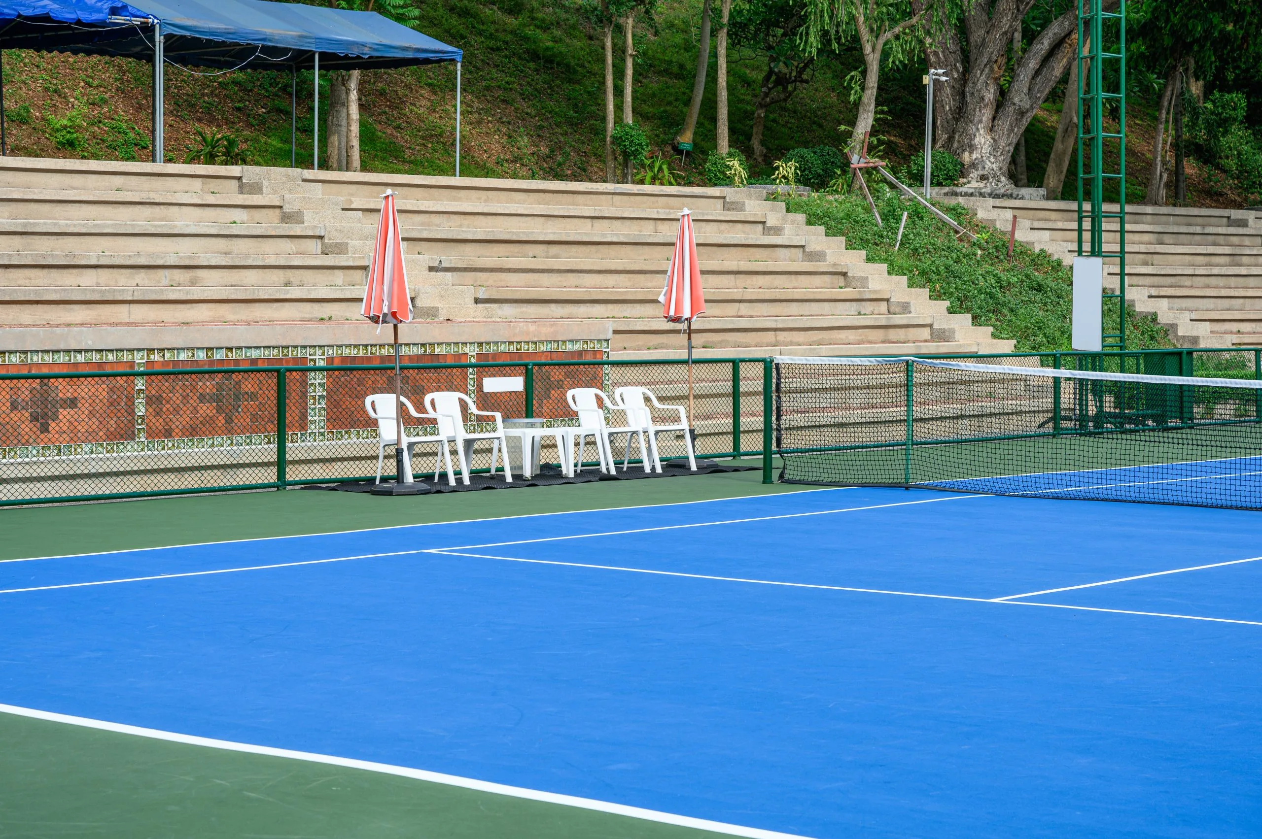 Tennis court with a specialty pavement coating