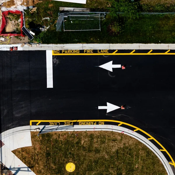 An aerial view of a road with arrows